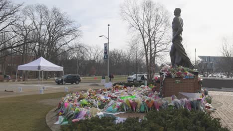 Spartan-Statue-on-the-campus-of-Michigan-State-University-with-flowers-after-the-mass-shooting-in-2023-with-gimbal-video-walking-behind