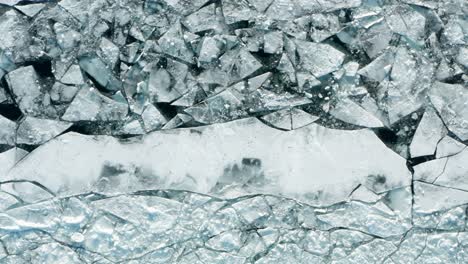 Aerial-top-down,-cracked-polar-ice-sheet-caused-by-climate-change