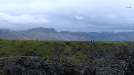 People-Hiking-at-Arnarstapi-on-Peninsula-Snæfellsnes-in-Iceland,-4K