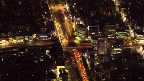 City-traffic-captured-at-night-time-lapse,-dynamic-movements-of-cars-at-bustling-highway-area-while-night-falls