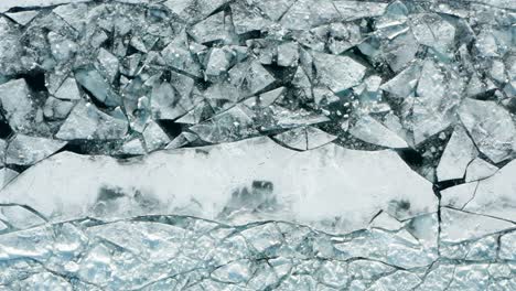 Aerial-top-down,-cracked-thin-ice-sheet-caused-by-global-warming