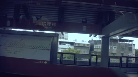 New-Taipei,-Taiwan-–-28.-Januar-2019:-Im-Inneren-Des-Sky-U-Bahn-Zugs,-Der-Sich-Nähert,-Blick-Auf-Den-Qilian-Bahnhof-Im-Offenen-Raum-Mit-Blick-Auf-Schmutzige-Ghetto-Altstadt-Slum-Wohngebäude-Im-Hintergrund