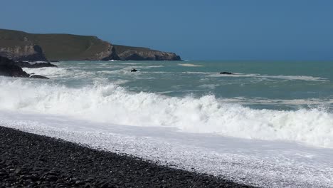 Waves-crash-onto-stony-beach-on-a-clear-summer's-day---Birdlings-Flat-Beach