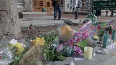 Berkey-Hall-on-the-campus-of-Michigan-State-University,-the-site-of-a-mass-shooting-in-February-of-2023-with-flower-memorial-and-gimbal-video-walking-low