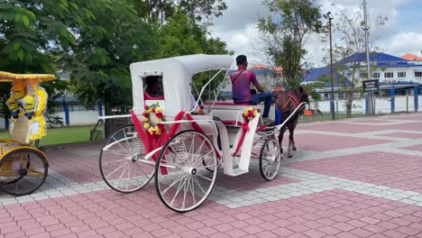 Tourists-enjoy-the-horse-carriage-ride-near-Malacca-historical-sites-in-Malaysia