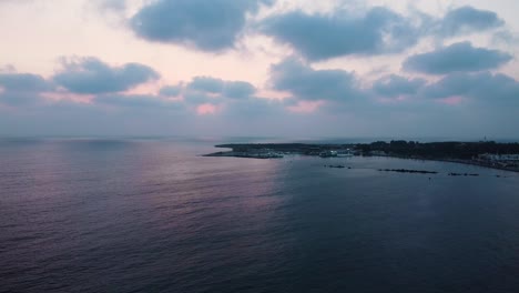 Aerial-drone-shot-in-Cyprus-of-the-sunset-over-the-sea---slow-push-in