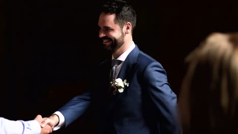 The-groom-stands-at-the-church-door-before-getting-married-to-greet-the-guests-at-the-wedding