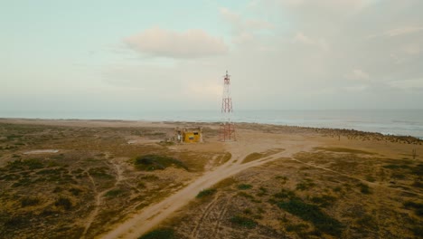 Aerial-view-of-a-lighthouse-in-the-desert-and-the-sea,-the-northest-point-in-Colombia-and-Southamerica,-La-Guajira,-Puntagallinas