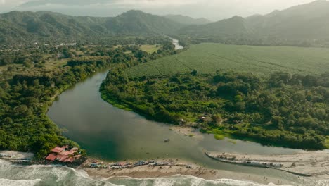 Aerial-view-where-the-sea-and-river-connects,-mountains,-Colombia,-la-guajira,-mendihuaca
