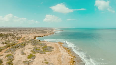 Aerial-shot-of-the-desert-beach-and-the-ocean,-Colombia,-La-Guajira