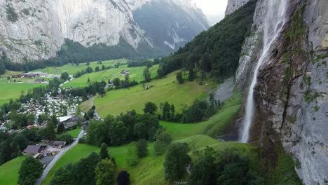 Lauterbrunnen-townscape-and-waterfall-drone-aerial-view-above-swiss-mountains-in-alps