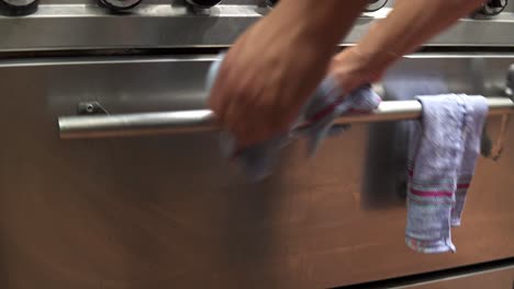Hand-held-shot-of-a-baker-removing-his-freshly-baked-goods-from-the-oven