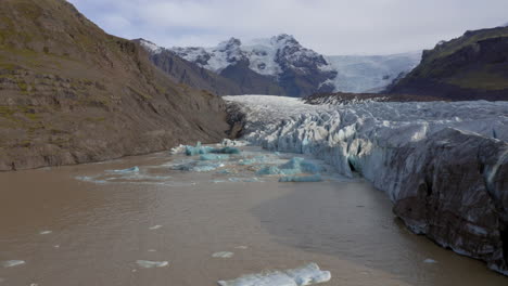Aerial:-Flying-towards-collapsing-icebergs-due-to-glacier-calving-on-Svinafellsjokull-glacier-in-Iceland