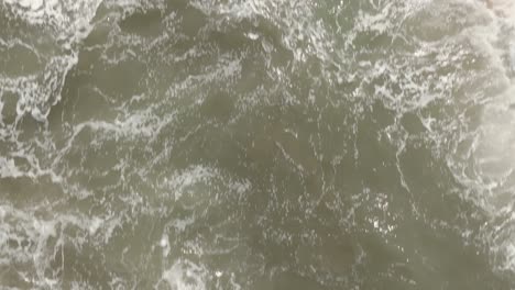 Aerial-drone-of-the-sea-waves,-close-up,-Colombia