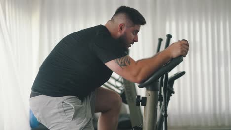Hard-Working-Young-Athlete-Trains-on-Spinning-Exercise-Bike