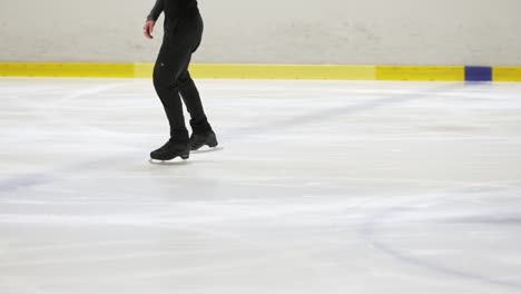 Young-ice-skater-softly-skating-in-slow-motion-on-ice-in-a-rink