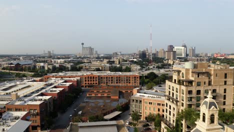 San-Antonio-Pearl-District-flying-past-brick-chimney-tower-towards-downtown-skyline-in-the-morning-with-4k-aerial-drone