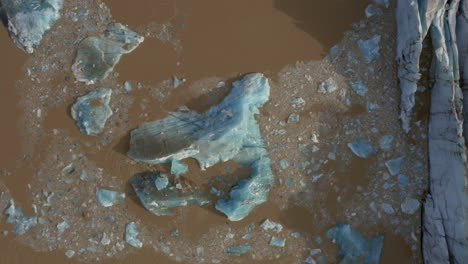 Aerial:-Bird's-eye-view-of-collapsing-icebergs-due-to-glacier-calving-on-Svinafellsjokull-glacier-in-Iceland