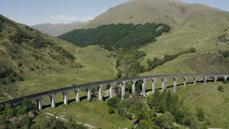 Wide-aerial-view-of-the-Glenfinnan-Viaduct-empty-on-a-bright-sunny-day