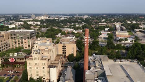 San-Antonio-Pearl-District-aerial-view-orbiting-brick-tower,-shops-and-restaurants-in-the-morning-adjacent-to-riverwalk-with-4k-drone