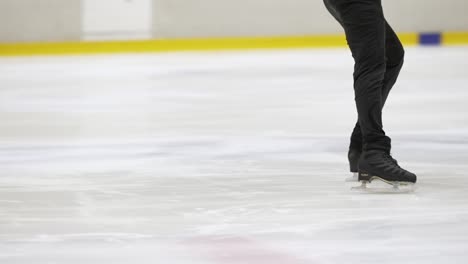 Male-ice-skater-in-slow-motion-scene-on-inside-ice-at-rink