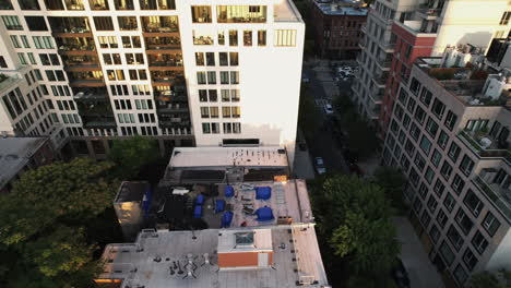 Aerial-view-in-front-of-a-apartment-revealing-downtown-of-Brooklyn,-golden-hour-in-NY,-USA---tracking,-tilt,-drone-shot
