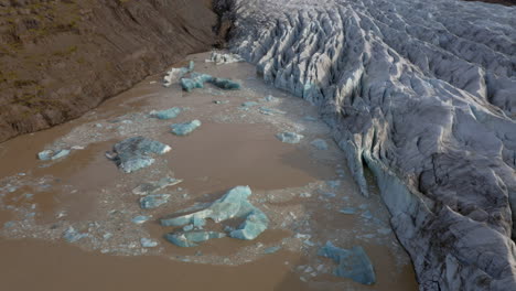 Drone-crane-shot-of-collapsing-icebergs-due-to-glacier-calving-on-Svinafellsjokull-glacier-in-Iceland