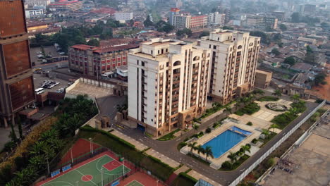 Aerial-view-around-luxury-condos,-in-sunny-downtown-Yaounde,-Cameroon---orbit,-drone-shot