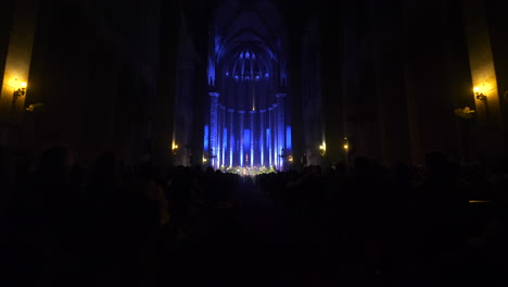 Glowing-stage-of-Santa-Maria-Cathedral-in-Barcelona-during-concert,-dolly-forward-view