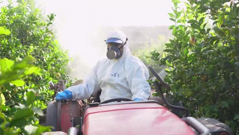 Farmer-in-protective-clothes-spray-pesticides