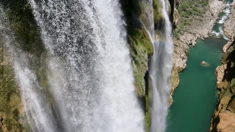 Aerial-View-Big-Tamul-Waterfall-drone-tilts-down-to-show-water-falling-with-Rainbow-in-San-Luis-Potosi-Mexico