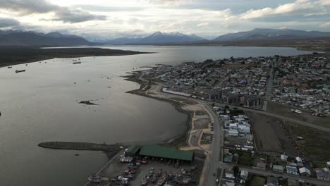 Patagonian-Landscape-City-of-Puerto-Natales-Chile,-Aerial-Drone-Above-Coast-Water-City-Architecture-and-Scenic-Skyline