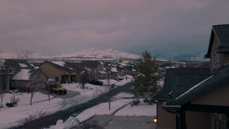 Snow-day-in-a-suburban-neighborhood-below-the-mountains---aerial-flyover