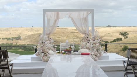 White-Luxury-Decorative-Indian-Wedding-Ceremony-Arch-Set-Up-Outdoors,-SLOW-MOTION