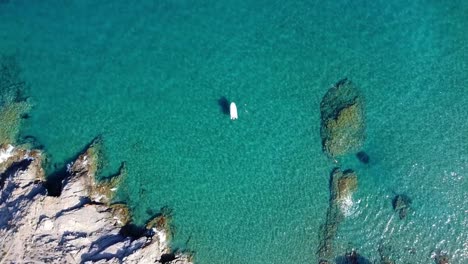 Yacht-relaxation-on-crystal-clear-turquoise-water-at-beach-in-the-south-of-Spain,-in-Murcia