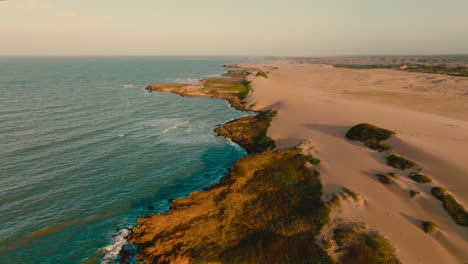 Aerial-view-flying-over-the-beach-in-the-desert-in-the-sunset,-Colombia,-la-guajira,-punta-gallinas