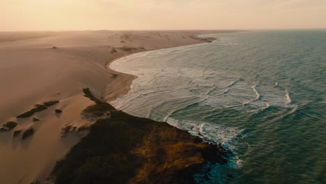 Aerial-view-flying-over-the-beach-in-the-desert-in-the-sunset,-Colombia,-la-guajira,-punta-gallinas