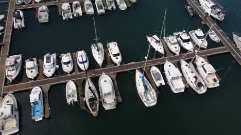 Sailboats,-Yachts,-and-Fishing-Boats-Docked-in-Marina-Harbour,-Aerial-Drone-View