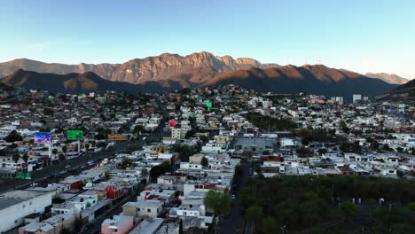 Drone-shot-flying-over-a-poverty-cityscape-in-Monterrey,-sunny-evening-in-Mexico