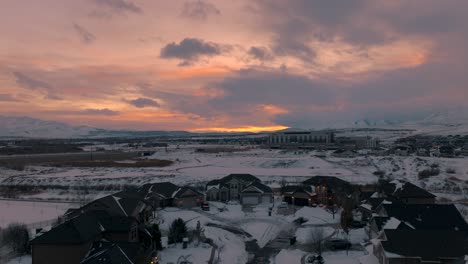 Snowy-suburb-in-winter-after-a-snowstorm-at-sunset---aerial-flyover
