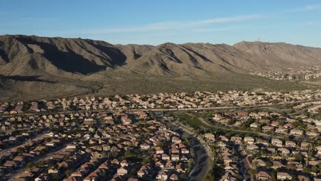 Aerial-View-of-Suburbs-in-Phoenix,-Arizona-with-South-Mountain-in-Late-Evening