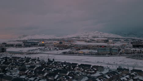 Silicon-slopes-in-Lehi,-Utah-at-dusk-after-a-snowstorm---aerial-pull-back-reveal