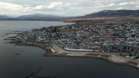 Cityscape-of-Puerto-Natales-Chilean-Patagonia,-Aerial-View-of-City,-Port-and-Summer-Horizon,-Montt-Gulf-in-Antarctic-Region