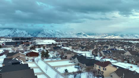 Snow-day-in-the-suburbs-below-the-mountains---aerial-flyover