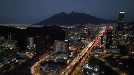 Aerial-view-towards-the-Latitud-apartment-building,-night-in-Monterrey,-Mexico