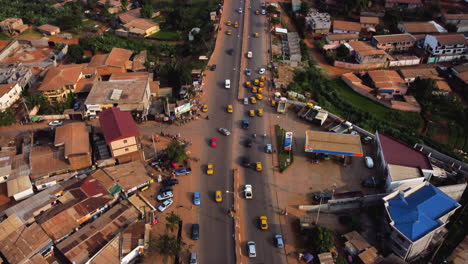 Aerial-view-tiltling-over-traffic-in-the-Etoug-Ebe-suburbs-of-Yaounde-city,-sunny-Cameroon,-Africa