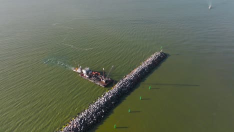 Aerial-view-A-breakwater-is-formed-and-fixed-with-the-help-of-special-equipment-and-a-ship
