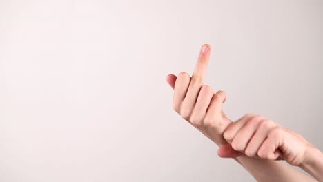 Hand-gesture-of-reeling-in-a-middle-finger-on-a-white-background