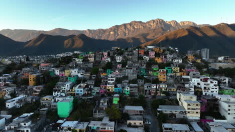 Aerial-view-of-colorful,-hillside-favela-house-in-Monterrey,-sunset-in-Mexico---descending,-drone-shot