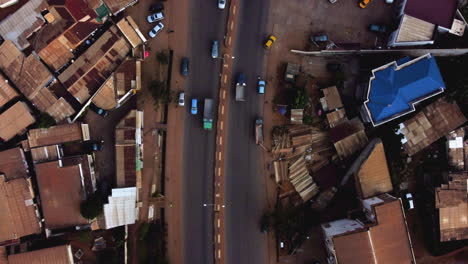Aerial-view-above-cars-on-a-road-in-Yaounde-city,-Cameroon---cenital,-drone-shot